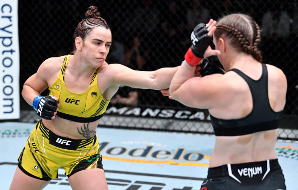 Norma Dumont of Brazil punches Aspen Ladd in a featherweight fight during the UFC Fight Night event at UFC APEX on October 16, 2021 in Las Vegas,...