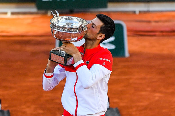 Novak DJOKOVIC of Serbia celebrates his victory with the trophy during the final round of Roland Garros at Roland Garros on June 13, 2021 in Paris,...