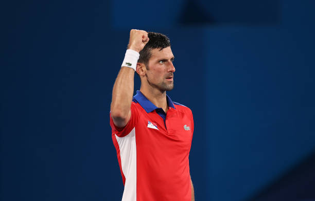 Novak Djokovic of Team Serbia celebrates victory after his Men's Singles Quarterfinal match against Kei Nishikori of Team Japan on day six of the...