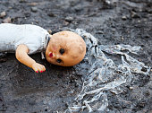 Old rejected dirty doll on the landfill