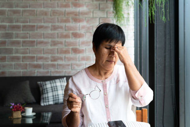 old woman headache while using smartphone, healthcare concept - angry asian old woman stock pictures, royalty-free photos & images