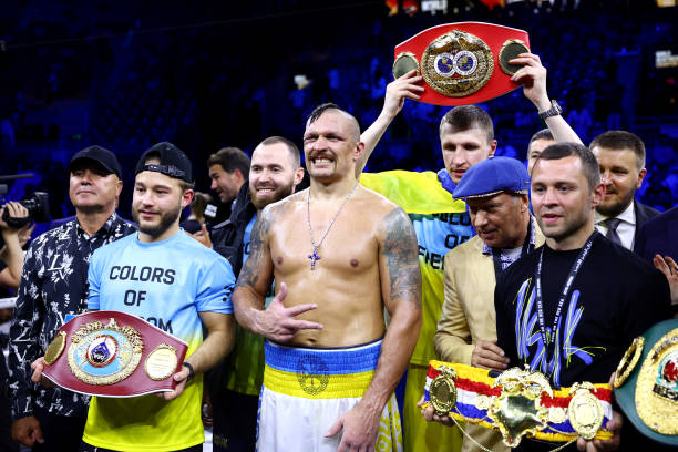 Oleksandr Usyk celebrates with their belts and team after their victory over Anthony Joshua in their World Heavyweight Championship fight during the...