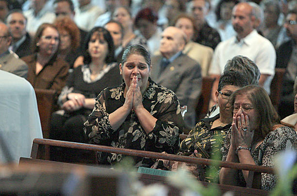 Olga Maria, reacts during a mass for her mother Cuban singer Olga Guillot at St. Michael's Catholic Church on July 15, 2010 in Miami, Florida. Olga,...