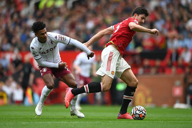 Ollie Watkins of Aston Villa with Harry Maguire of Manchester United during the Premier League match between Manchester United and Aston Villa at Old...