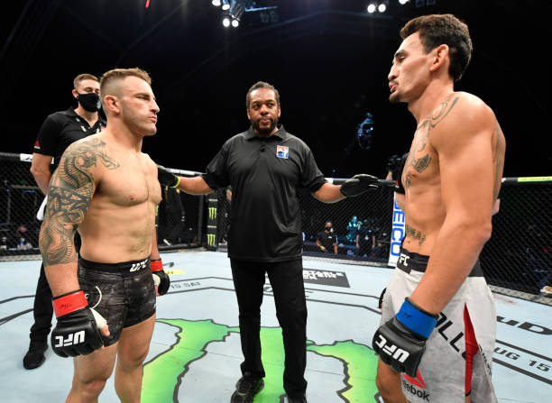 Opponents Alexander Volkanovski of Australia and Max Holloway face off prior to their UFC featherweight championship fight during the UFC 251 event...