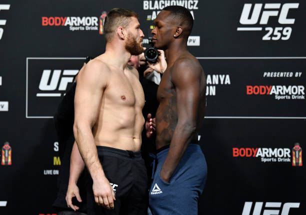 Opponents Jan Blachowicz of Poland and Israel Adesanya of Nigeria face off during the UFC 259 weigh-in at UFC APEX on March 05, 2021 in Las Vegas,...