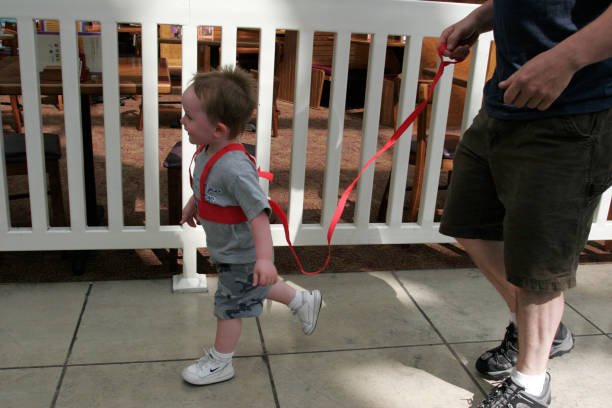 Orlando Airport, boy in harness with leash.
