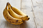 Overripe bananas on wooden table