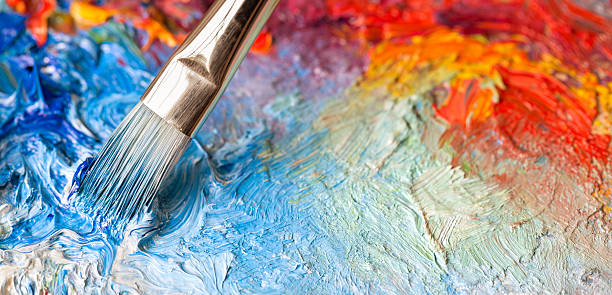 paintbrush with oil paint on a classical palette - visual arts stock pictures, royalty-free photos & images