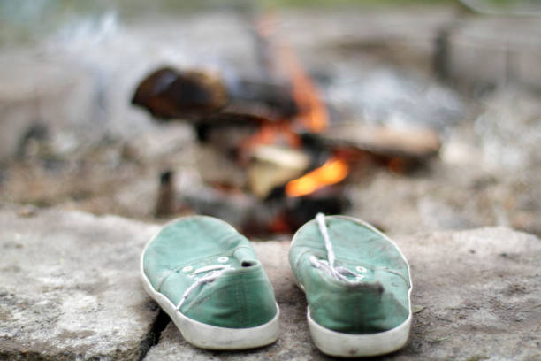 Pair of green trainers and campfire, Koppert, Washington, USA