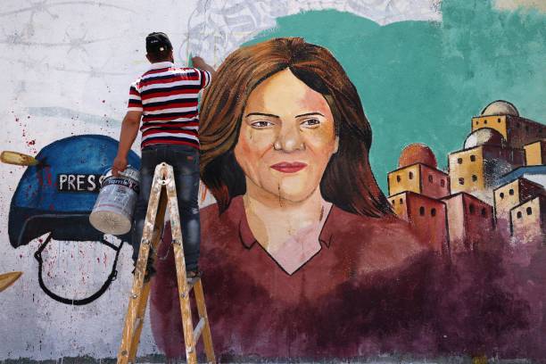 Palestinian artists paint a mural in honour of slain veteran Al-Jazeera journalist Shireen Abu Akleh in Gaza City on May 12, 2022. - Abu Akleh, who...
