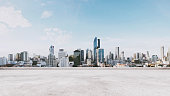 Panoramic city view with empty concrete floor