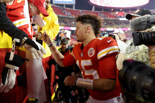 patrick mahomes of the kansas city chiefs signs autographs after the picture