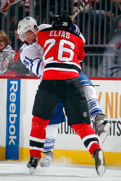 patrik-elias-of-the-new-jersey-devils-checks-phil-kessel-of-the-picture-id165882220