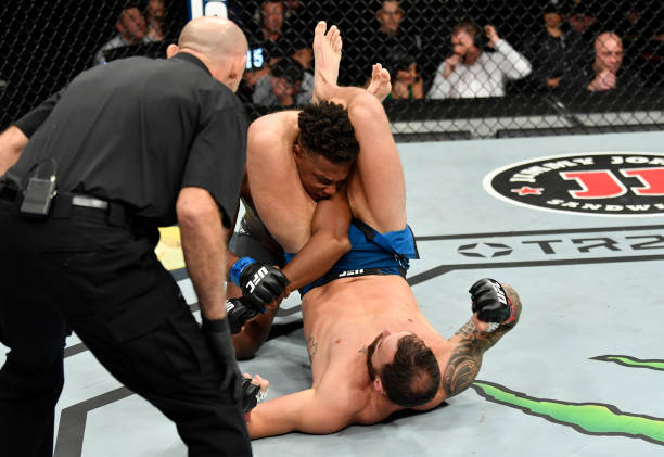 Paul Craig of Scotland elbows Jamahal Hill while in a triangle choke in their light heavyweight fight during the UFC 263 event at Gila River Arena on...
