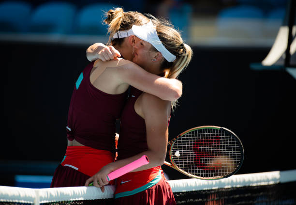 Paula Badosa of Spain shares a friendly moment at the net with Marta Kostyuk of Ukraine after beating Kostyuk in her third-round singles match at the...