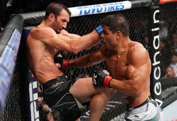Paulo Costa of Brazil punches Luke Rockhold in a middleweight fight during the UFC 278 event at Vivint Arena on August 20, 2022 in Salt Lake City,...