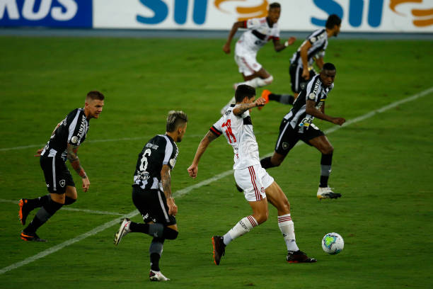 Pedro of Flamengo fights for the ball with Victor Luis of Botafogo during the match between Botafogo and Flamengo as part of the Brasileirao Series A...