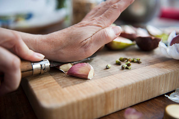 peeling the garlic - garlic stock pictures, royalty-free photos & images