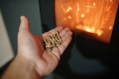 Pellet / Biomass heating - Human hand holding biomass pellets