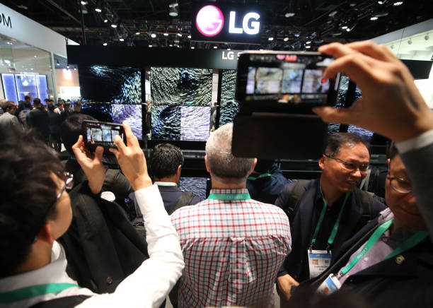 people take photos of the lg signature oled r rollable televisions at picture