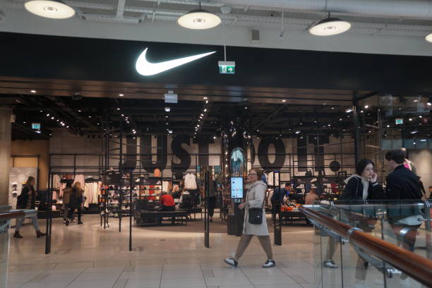 People walk near the entrance to Nike store, May 25, 2022 in Moscow, Russia. Nike Inc. With its 116 Russian stores and British retailer Marks and...