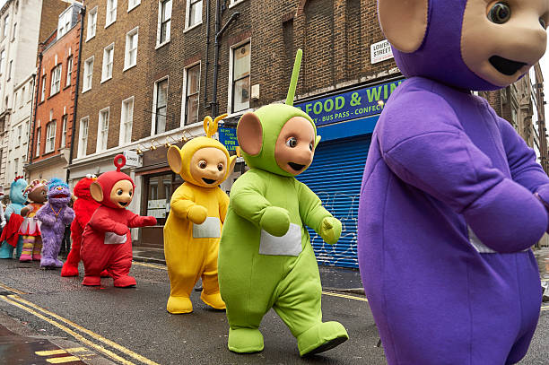 Performers dressed as children's toys and characters from television shows, including the Teletubbies, prepare to participate in the Hamleys...