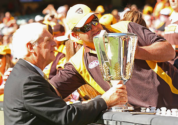 Peter Hudson shows the Premiership Cup to the crowd during the round two AFL match between the Hawthorn Hawks and the West Coast Eagles at the...