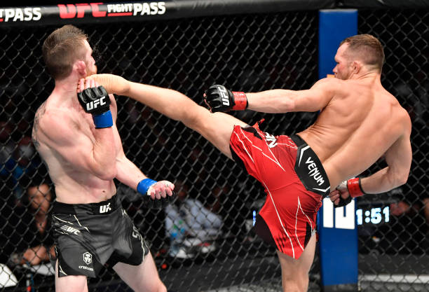 Petr Yan of Russia kicks Cory Sandhagen in the UFC interim bantamweight championship fight during the UFC 267 event at Etihad Arena on October 30,...