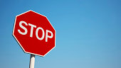 Photo of a stop sign with blue sky background