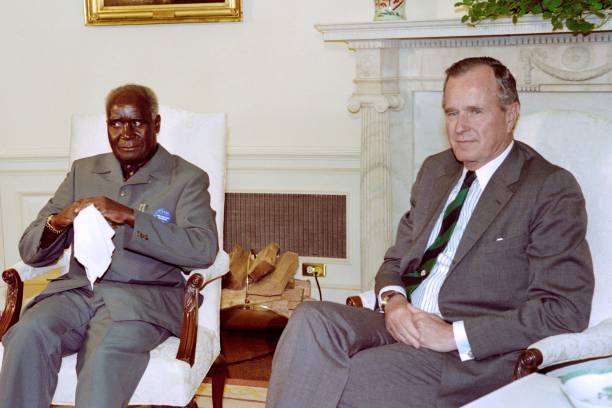 A photo taken on June 7 1989 shows Zambian President Kenneth Kaunda with US President George Bush in the Oval Office at the White House in Washington...