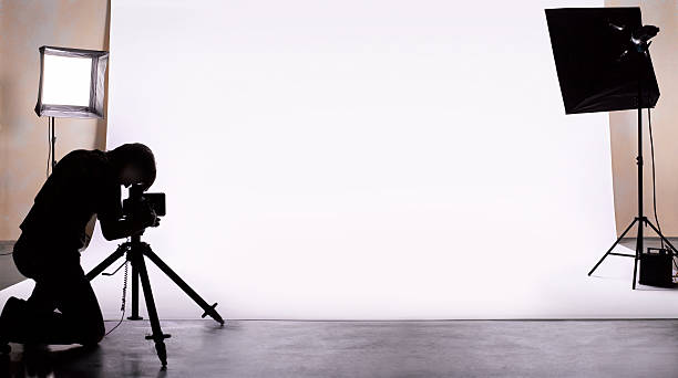 photographer shooting in studio. - photographer stock pictures, royalty-free photos & images