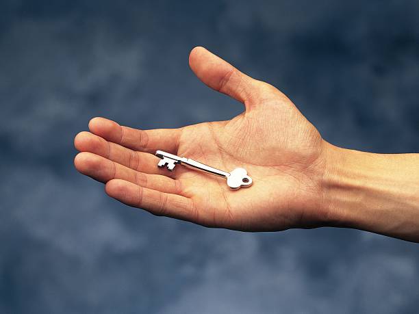 photography of a key put on palm, high angle view - key on the palm of hand stock pictures, royalty-free photos & images