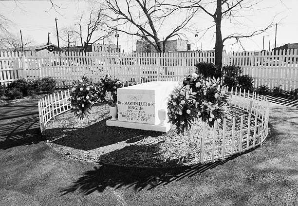Picket fences and flower arrangements surround the grave of Martin Luther King Jr.