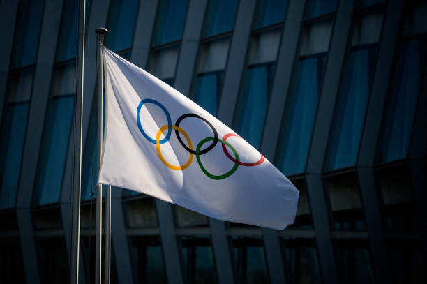 Picture taken on March 8, 2021 in Lausanne shows the Olympic flag floating next to the headquarters of the International Olympic Committee ahead of a...