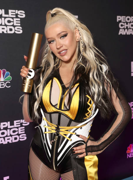 Pictured: Christina Aguilera, recipient of The Music Icon of 2021 award, poses backstage during the 2021 People's Choice Awards held at Barker Hangar...