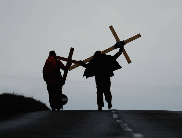 Pilgrims celebrate Easter by crossing over the tidal causeway carrying wooden crosses on the final leg of their annual pilgrimage to the Holy Island...