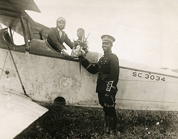 Pilot Bessie Coleman of Chicago, the first female African American aviator in the world, receiving a bouquet from Captain Edison C McVey in his...