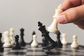Plan leading strategy of successful business competition leader concept, Hand of player chess board game putting white pawn, Copy space for your text