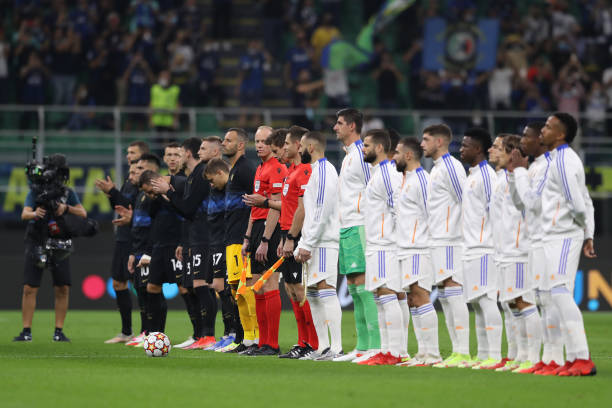 Players and officials line up in front of the steadycam for the anthem prior to kick off in the UEFA Champions League group D match between Inter and...