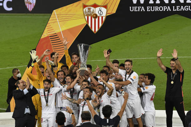 Players of Sevilla celebrate their victory after their team crowned 2020 UEFA Europa League champions with a 32 win against Italy's Inter Milan at...