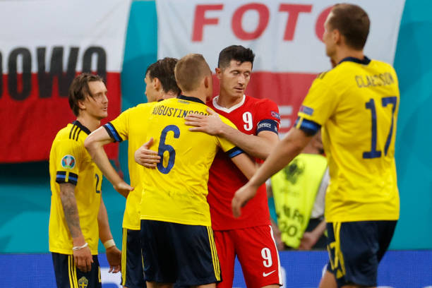Poland's forward Robert Lewandowski embraces Sweden's defender Ludwig Augustinsson after the UEFA EURO 2020 Group E football match between Sweden and...