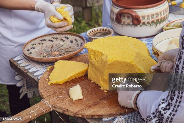 womans hands cut polenta table with