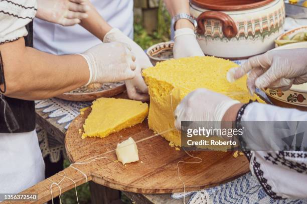 womans hands cut polenta table with