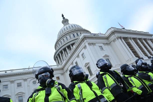Police stand as supporters of US President Donald Trump protest outside the US Capitol on January 6 in Washington, DC. - Demonstrators breeched...