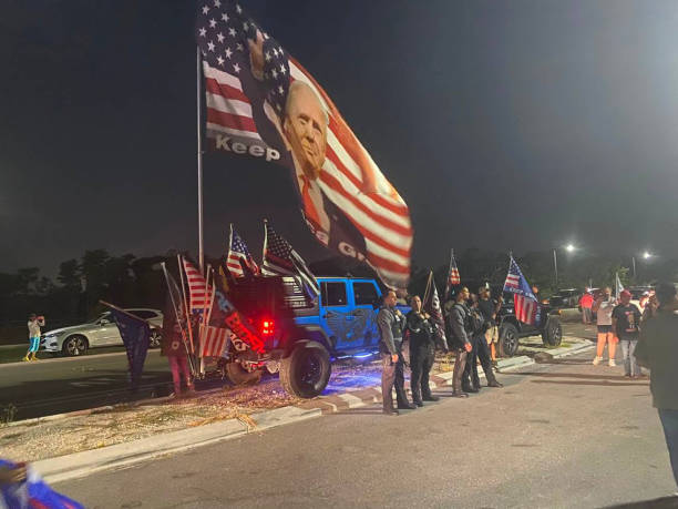 Police standby at the approach to Mar-a-Lago in Palm Beach on Monday night, Aug. 9 as supporters of former President Donald Trump turn out after an...