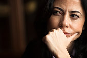 Portrait of a pensive woman with a furrowed brow