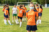 COVID-19. Portrait of a young football player wearing face mask due to coronavirus pandemic.