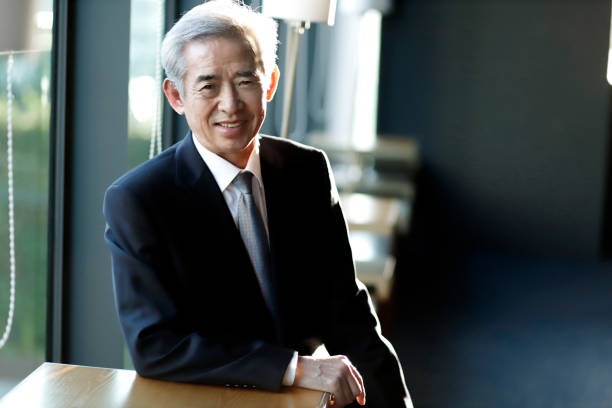 portrait of smiling senior businessman - old asian guy in the office stock pictures, royalty-free photos & images