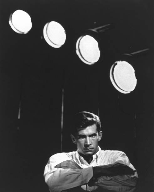 Posed portrait of American actor Anthony Perkins in front of studio lights circa 1960.